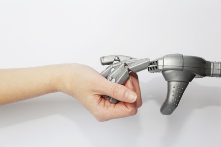 Robot and man. The hand of a living person and the hand of a robot together. Modern technology and...