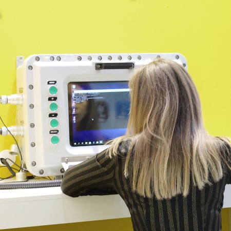 The girl operator is sitting behind an explosionproof