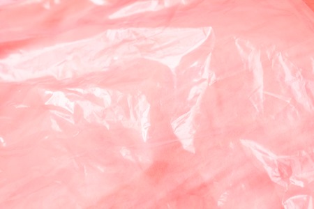 The texture of the pink polyethylene package. Background for cards. Template for lettering. Pink...