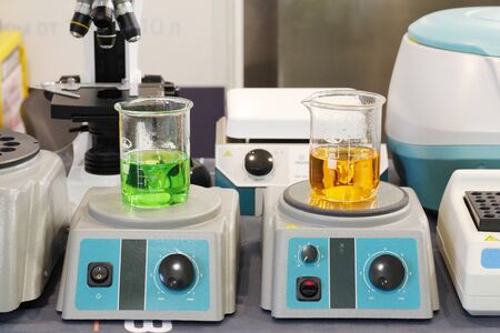 Chemical laboratory in which experiments are carried out. Flasks and test tubes stand on devices for chemical synthesis.の写真素材