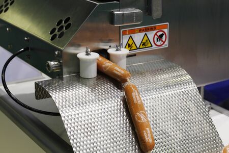 Moscow, RF, 10.10.2019: Sausage packing machine. The device packs sausages in a film. Factory for...