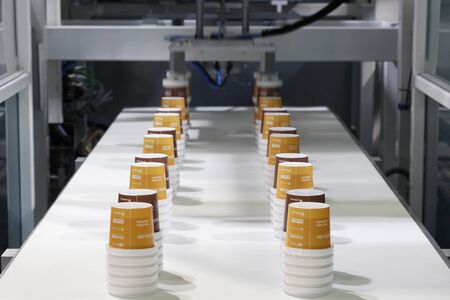 A fragment of a machine for the production of disposable plastic cups. Work on high-performance and precision pressurized machines. Goods are made for sale with coffee or tea.のeditorial素材