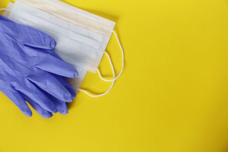 COVID-19. Coronavirus. Coronavirus infection. Several disposable medical face masks and a pair of...