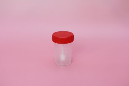 Jars for analysis on a pink background. Containers for feces and urine. The containers are empty....