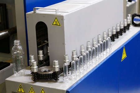 Blowing machine for plastic bottles. High-tech production of plastic bottles in the factory....