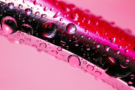 Drops of water on the handle for a bath on a pink background の写真素材
