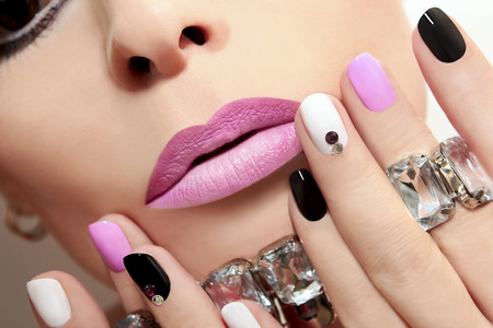 Fashion nails with rhinestones and colored nail Polish.