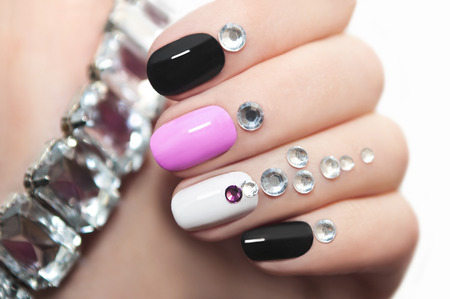 Colorful manicure oval shape nails with rhinestones.