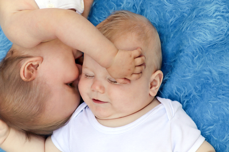 Curious, funny and funny babies on blue background.の写真素材