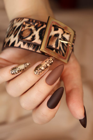 Luxurious multicolored beige brown manicure with animal design on long nails.の写真素材