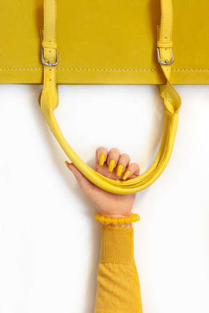 Fashionable yellow on the bag and on the girl's manicure.の写真素材