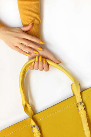 Fashionable yellow on the bag and on the girl's manicure.の写真素材