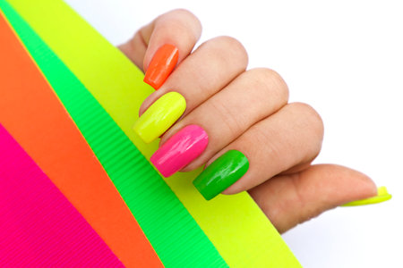 Bright illuminating multicolored fashionable manicure on a woman's hand.の写真素材
