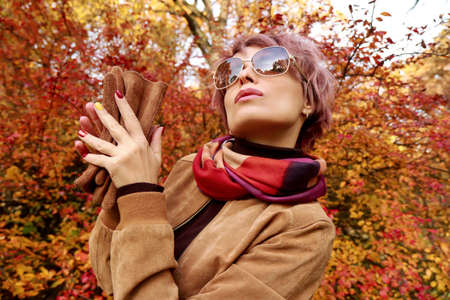 A model with accessories and a multi-colored manicure in autumn.の写真素材