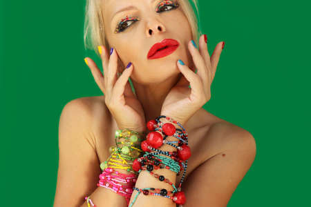 Creative makeup and manicure on a girl with beaded jewelry.の写真素材