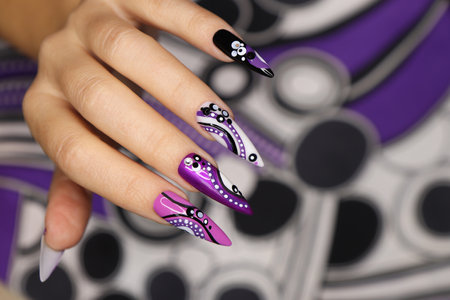 Manicure on long nails with dots and lines.の写真素材