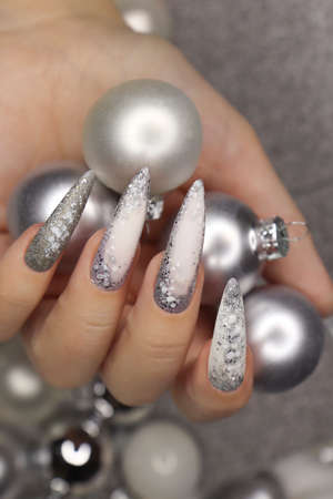 Manicure on long nails with silver glitter.の写真素材