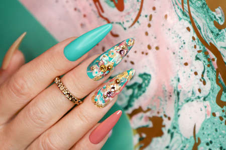 Creative color manicure with rhinestones on long nails.の写真素材