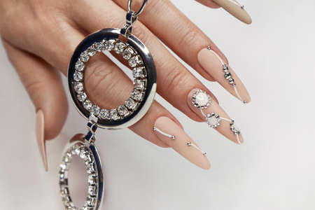Nude manicure with rhinestones on long nails.の写真素材