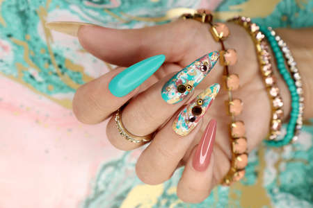 Creative color manicure with rhinestones on long nails.の写真素材