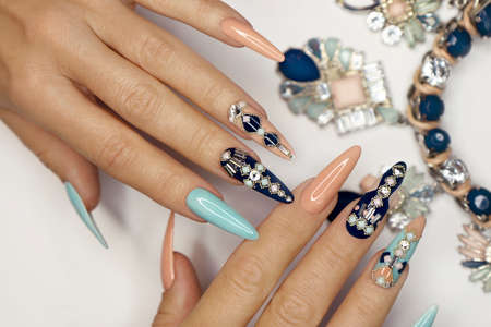 Blue pink manicure with a design of square rhinestones and small balls.の写真素材