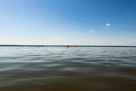 The water surface in summer in sunny weather with clouds in the blue sky.の写真素材