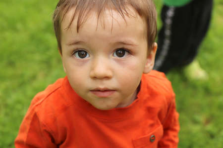 A little boy plays with soap bubbles in the summer outdoors.の写真素材