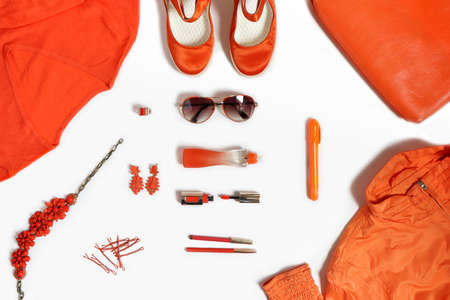 Fashionable items of women's clothing and accessories in orange on a white background.の写真素材
