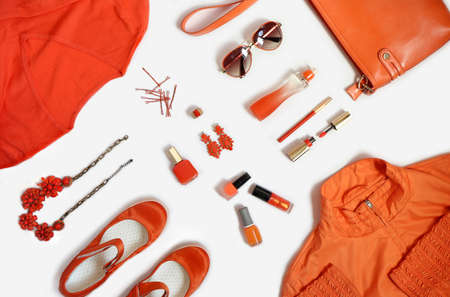 Fashionable items of women's clothing and accessories in orange on a white background.の写真素材