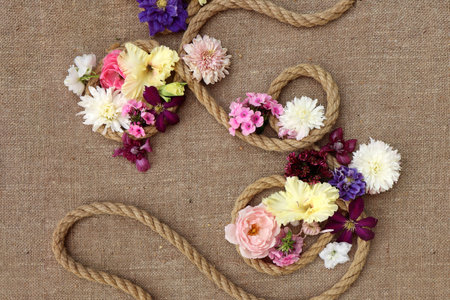 Floral arrangement of various colors on burlap.の写真素材