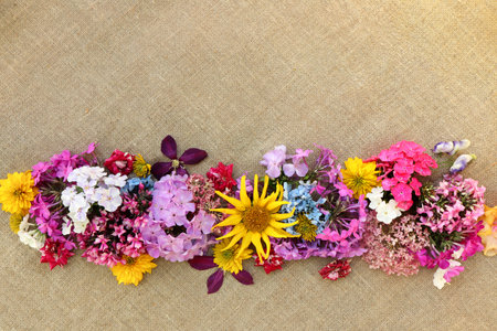 Floral arrangement of a variety of flowers on burlap.の写真素材