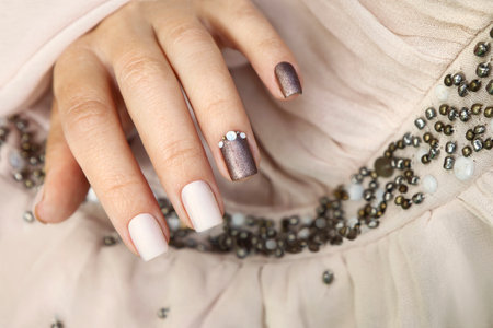Milk chocolate manicure with rhinestones on short nails.の写真素材