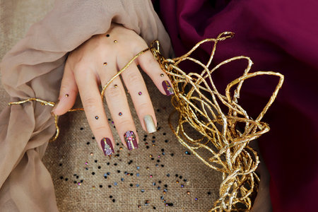 Plum manicure with sliders and rhinestones on square nails.の写真素材