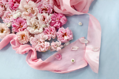 Floral arrangement of pink and white roses on a blue background.の写真素材
