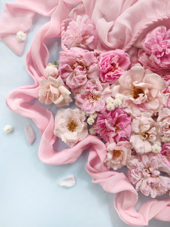 Beautiful floral composition with pink roses on blue background. Flat lay, top viewの写真素材