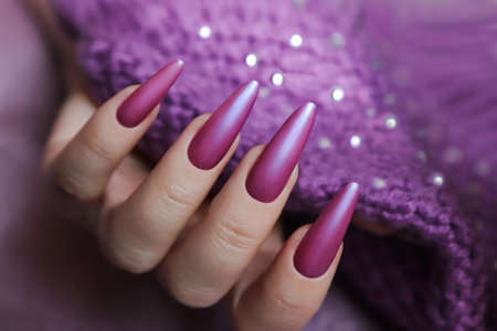 A long nail extension with a lilac coating of nail polish.の写真素材