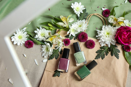 Nail polish and flowers on table, top view. Beauty conceptの写真素材