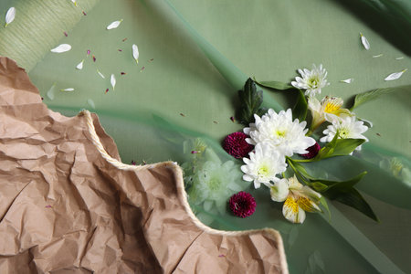 Bouquet of flowers on a green background with crumpled paperの写真素材
