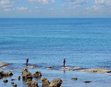 Fishers at low tide of Mediterraneanの写真素材