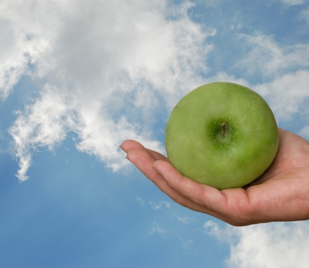 Hand with green appleの写真素材
