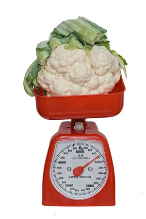 Kitchen scale weighting broccoflower isolated on white backgroundの写真素材