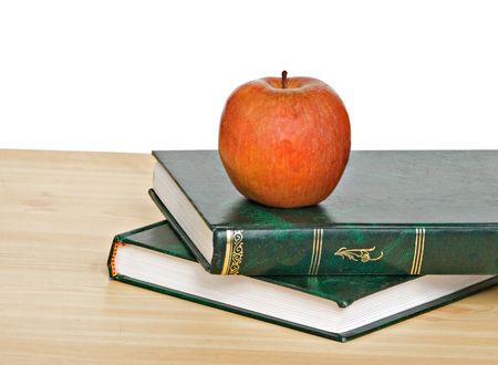 Red apple on books on deskの写真素材
