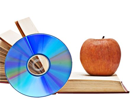 Apple, dvd, and open book as  symbols of transition fron old to new ways of learningの写真素材