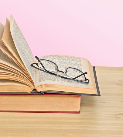 Glasses on open bookの写真素材