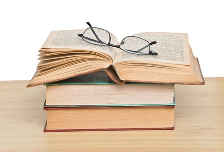 Glasses on open bookの写真素材