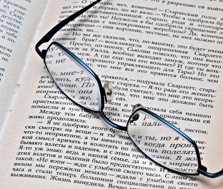 Glasses on open bookの写真素材