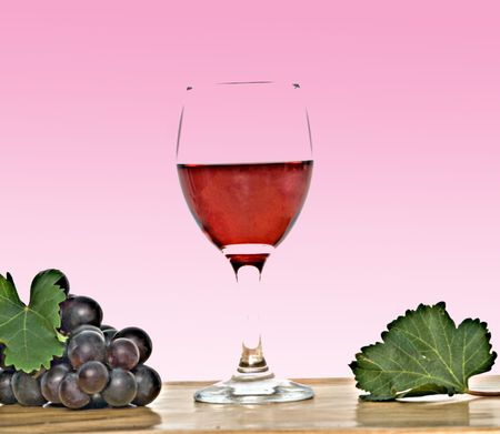Goblet with wine and grapevine isolated on white background の写真素材