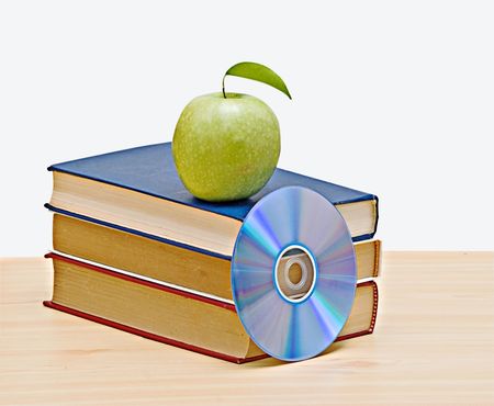 Apple, dvd, and books as a symbol of transition from old to new ways of learning