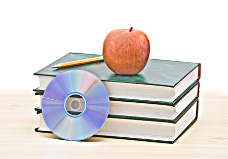 Apple, dvd, and books as a symbol of transition from old to new ways of learningの写真素材