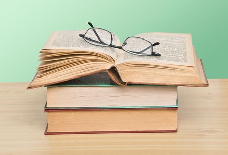 Eyeglasses on open bookの写真素材